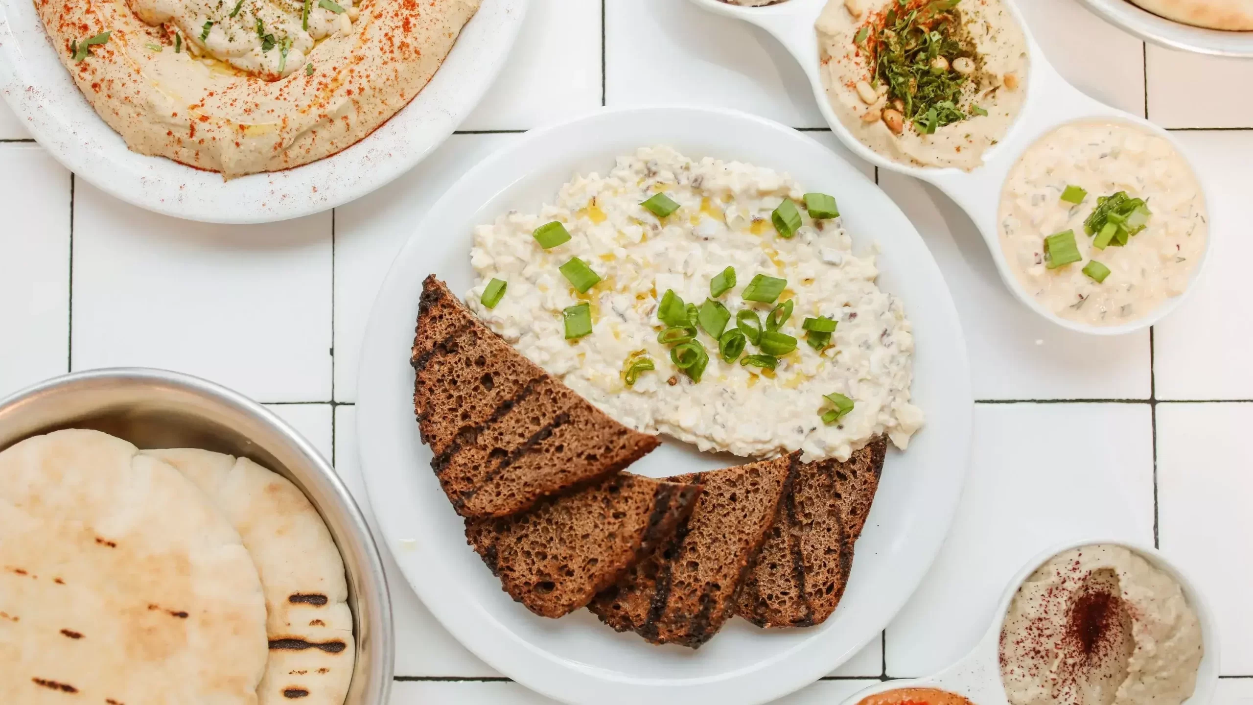 A top view of Mediterranean-style dip and rye bread_compressed